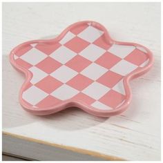 a pink and white checkered flower shaped dish