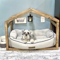 a dog is sitting in his bed on the floor