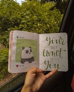 someone is holding up a book with an image of a panda bear in the pages