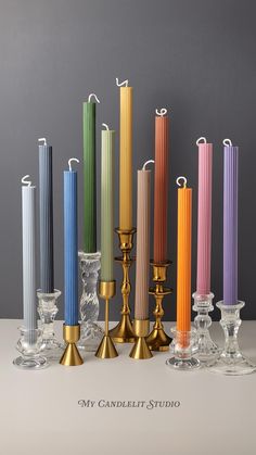 many different colored candles are lined up in a row