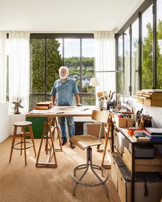 an older man is standing in his home office