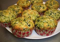 several muffins on a white plate sitting on a table