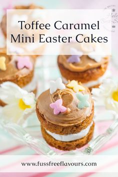 some cupcakes with frosting on top and flowers in the middle are sitting on a glass plate