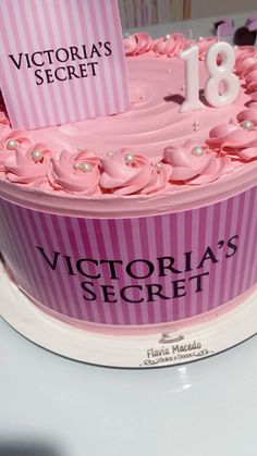 a birthday cake with pink icing and white frosting on top that says victoria's secret