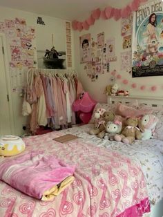 a pink and white bedroom with teddy bears on the bed