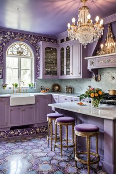 a kitchen with purple walls and cabinets, chandelier above the stove top island