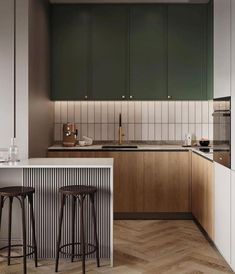 a kitchen with green cabinets and wooden flooring