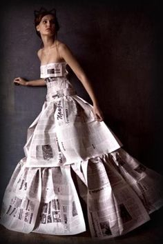 a woman in a dress made out of newspapers