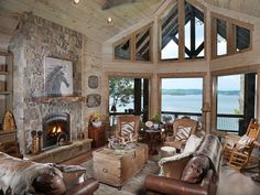 a living room filled with furniture and a fire place in front of a stone fireplace