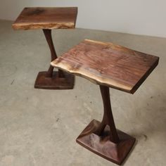 two wooden tables sitting on top of each other in the middle of a cement floor