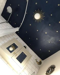 a bathroom with stars painted on the ceiling