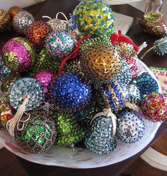 a bowl filled with lots of different colored ornaments