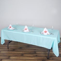 the table is set with napkins and wine glasses