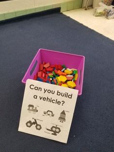 a pink bin filled with legos and a sign that says can you build a vehicle?