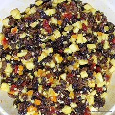 a white bowl filled with fruit and nuts