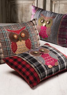 two decorative pillows with owls on them