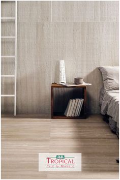 a bed room with a neatly made bed and a book shelf on the side table