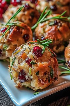 small appetizers with cranberries and herbs on a white plate