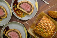 four plates with pastries on them sitting on a table