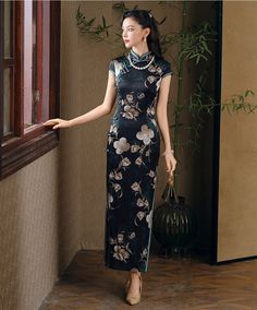 Step into elegance with this luxurious black silk qipao adorned with an exquisite floral design. The dress features a high Mandarin collar and traditional frog buttons, giving it a refined, authentic look. The rich green floral motif, interspersed with delicate cream and gold blossoms, adds a touch of nature-inspired beauty, making it perfect for formal occasions, evening events, or as a statement piece for special gatherings. Material: 90% Mulberry Silk, 10% Spandex Size Guide: Please note Asia Elegant Floral Print Cheongsam With Stand Collar, Green Elegant Cheongsam With Stand Collar, Elegant Green Cheongsam With Stand Collar, Elegant Fitted Cheongsam With Floral Print, Elegant Floral Embroidered Dress With Stand Collar, Traditional Floral Print Formal Dress, Elegant Ao Dai With Floral Embroidery, Elegant Black Cheongsam For Spring, Elegant Green Dress With Stand Collar