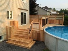 a wooden deck next to a swimming pool