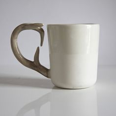 a white coffee cup with antlers on it