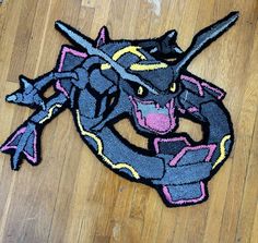 a patch on the floor that has a dragon in it's head and two swords sticking out of its mouth