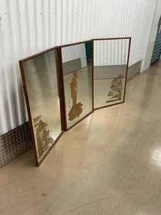 three mirrors sitting next to each other on the floor