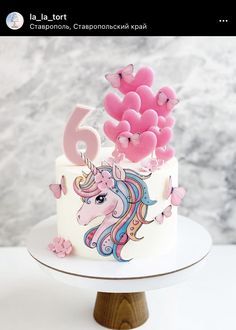 a birthday cake decorated with pink balloons and a unicorn on the top that says 6th