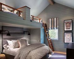 a bedroom with bunk beds and pictures on the wall above it, along with a ladder