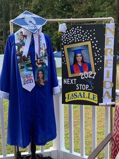 a graduation gown and cap on display in front of a sign that reads, next stop lasalle