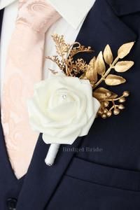 a man wearing a suit and tie with a white rose on it's lapel