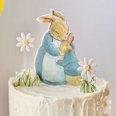 there is a cake with an image of a bunny holding a baby rabbit on it