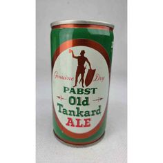 an old tinkered ale can with a man holding a surfboard