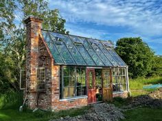 an old brick house with a glass roof