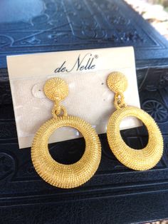 This is a beautiful pair of vintage gold hoop pierced earrings on the original card marked De Nelle. These a textured yellow matte gold that glisten in the light, I believe they are gold plate, the metal is not magnetic. I do not believe these were ever worn. The earrings are 2 1/2 in. long, and are in great vintage condition. Thank you for looking! Gold Statement Earrings, Original Card, Pierced Earrings, Jewelry Earrings Hoops, Gold Hoop, Matte Gold, Gold Hoop Earrings, Earrings Gold, Earings Piercings