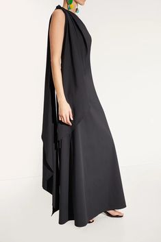 This dramatic yet chic silhouette from Simon Miller is the perfect wedding look. It's lightweight and perfect for those summer parties. Pair it with the Raffia Slide for a beach look or dress it up with the Beep Thong Heels in silver. Chic Draped Summer Maxi Dress, Chic Draped Maxi Dress For Summer, Modern Summer Maxi Dress For Formal Occasions, Summer Wedding Draped Maxi Dress, Elegant Asymmetrical Vacation Dress, Flowy Maxi Dress For Summer Gala, Summer Gala Dress Asymmetrical, Summer Gala Asymmetrical Dress, Asymmetrical Maxi Dress For Summer Evenings