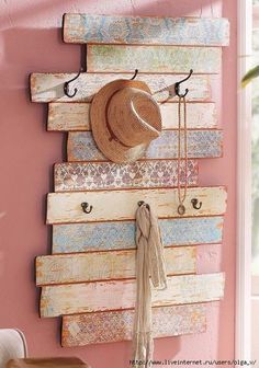 a wall mounted coat rack with hats on it