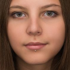 a close up of a person wearing a nose ring with a diamond in the middle