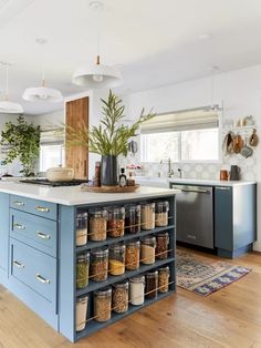 a kitchen filled with lots of different types of spices and seasonings on top of blue cabinets