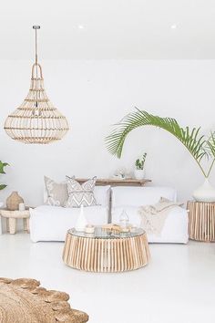 a living room filled with furniture and plants