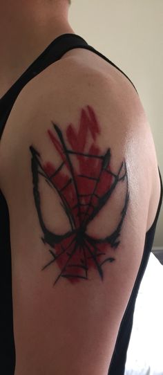 a man with a spiderman tattoo on his arm