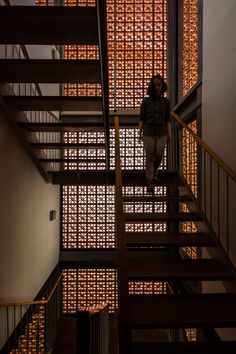 a woman standing on top of a stair case