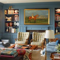 a living room filled with furniture and bookshelves