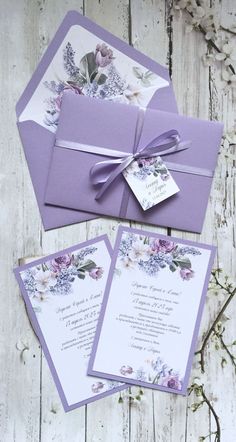 the wedding stationery is purple and has flowers on it