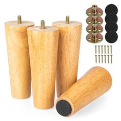 three wooden pegs with screws and nails in front of them