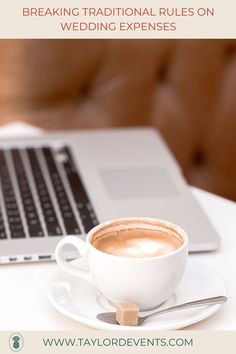 a cup of coffee sitting on top of a saucer next to a laptop computer