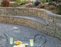 an outdoor patio with stone steps and seating area