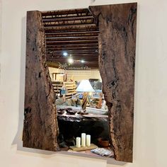 a mirror that has been cut in half to look like it is being displayed on the wall