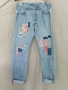 an old pair of jeans with patches and flowers on them